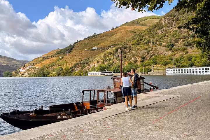 Traditional rabelo boat on Douro River for 1-hour cruise during private Douro Valley wine tour from Porto