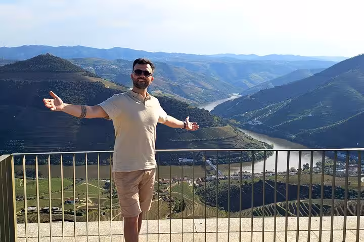 Scenic Douro Valley viewpoint over winding Douro River and vineyards on private wine tour from Porto with cruise and lunch