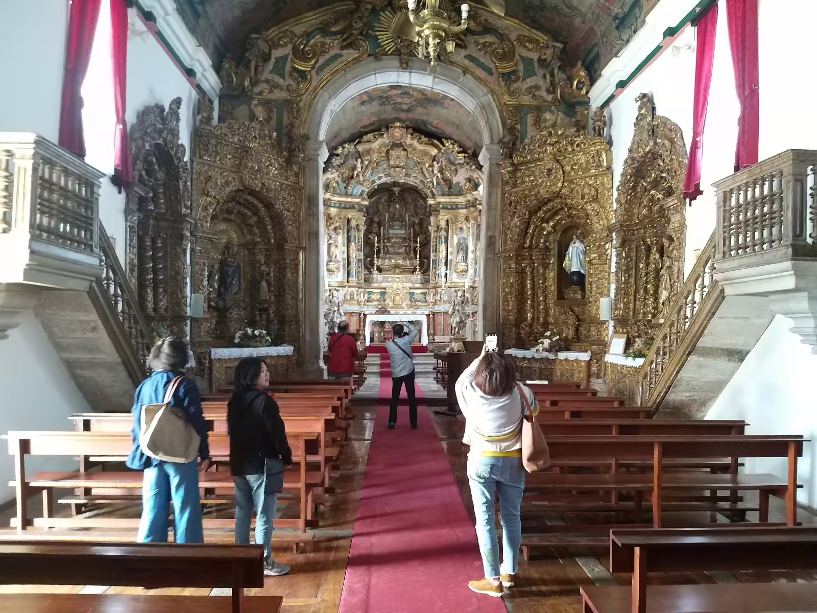 Visitors admire ornate architecture inside a historic church on the Stunning Douro Valley private winery tour.