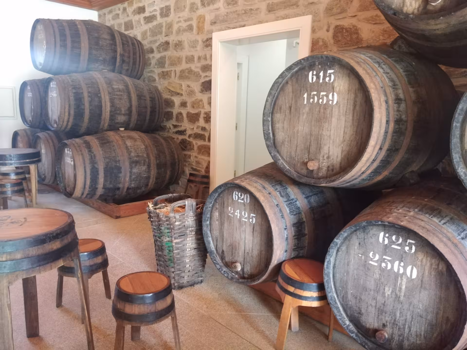 Traditional Douro wine cellar with stacked oak barrels, part of an exclusive discovery moment winery tour and tasting