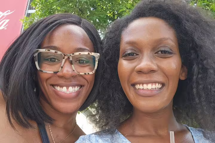Two smiling women enjoying Downtown Atlanta Walking Tour outdoor activity together