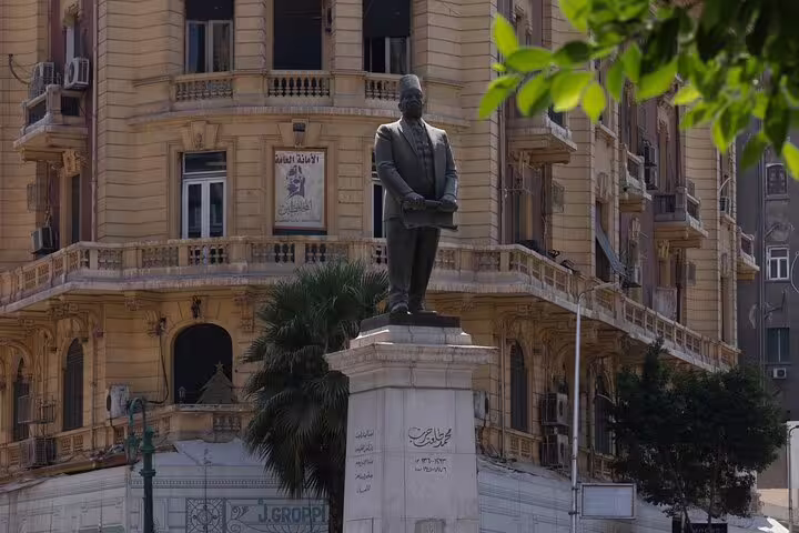 Historic Downtown Cairo statue beside ornate colonial building on a half-day tour with Egyptian dinner