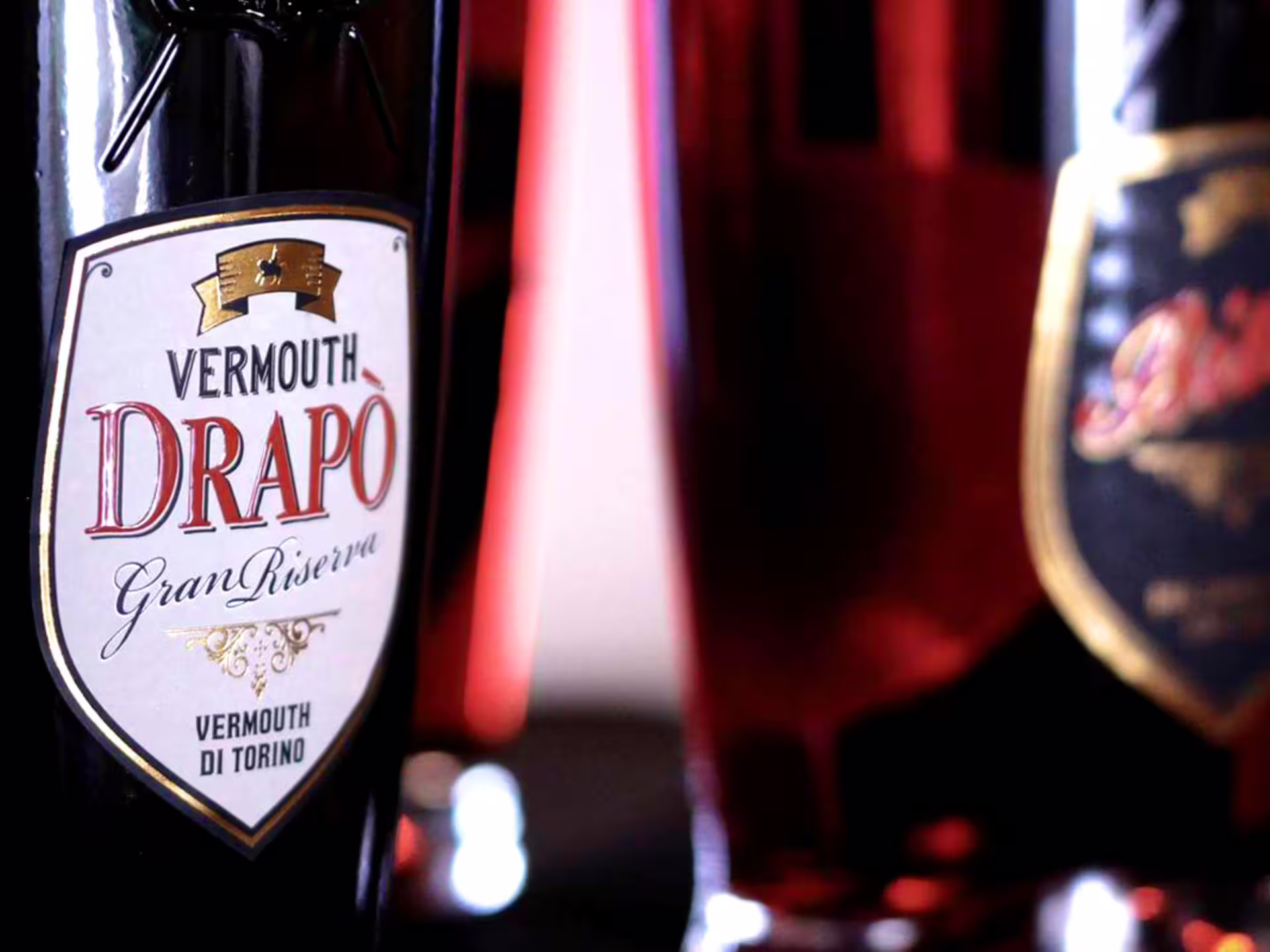 Discover Drapò Gran Riserva Vermouth in Turin with its elegant bottle showcased in a sophisticated setting.