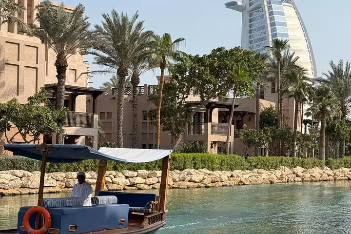 Abra boat ride at Madinat Jumeirah with Burj Al Arab backdrop on Dubai city tour with Ain Dubai