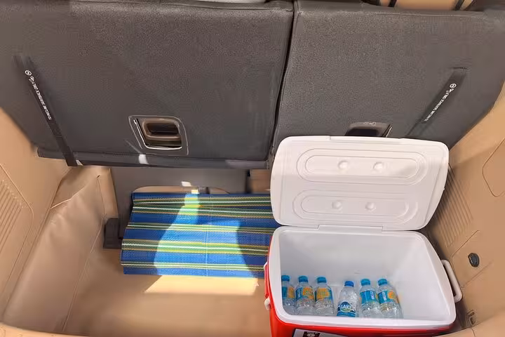 Car trunk with cooler and bottled water for comfortable Dubai to Abu Dhabi private transfer service