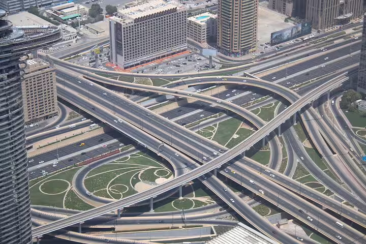 Aerial view of Dubai highway interchange and city towers on a private full-day customizable sightseeing tour by car