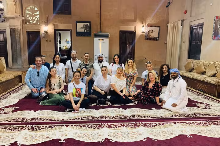 Group photo at Al Fahidi Historical Neighbourhood cultural stop on Dubai city tour from Ras Al Khaimah, kids free