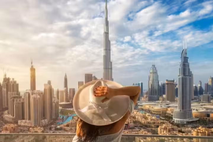 Woman enjoying panoramic views of Dubai skyline, featuring the iconic Burj Khalifa, on a private city sightseeing tour.