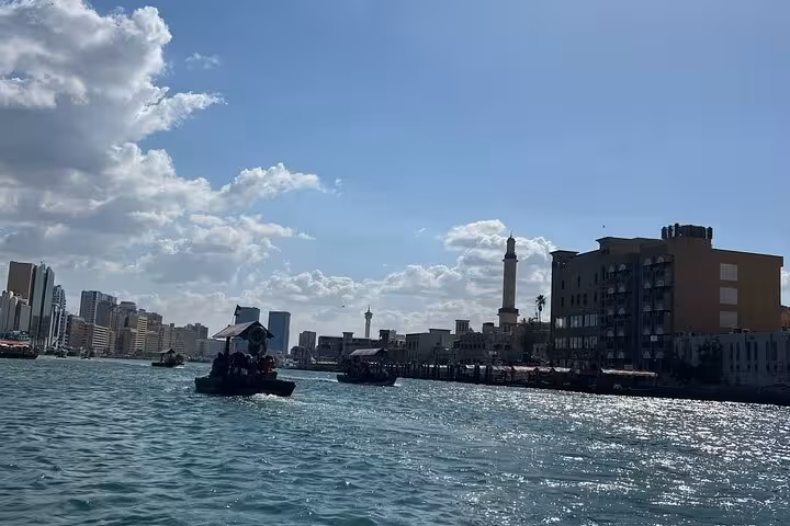 Dubai Creek abra boat ride view on private Dubai tour, historic waterfront skyline, with Burj Khalifa entry ticket