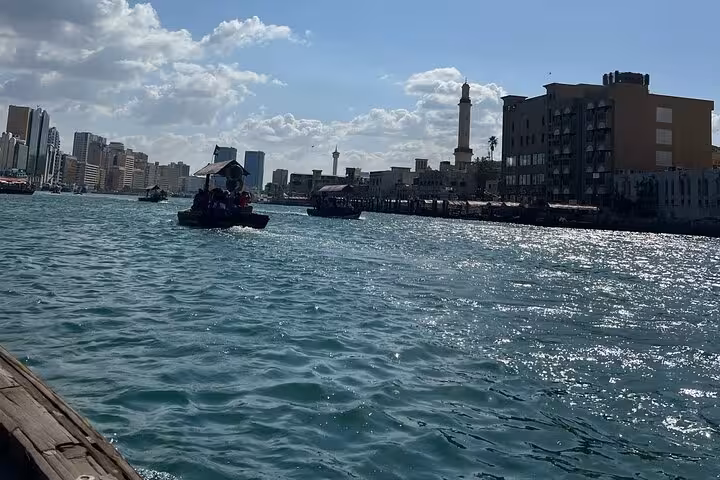 Traditional abra boats on Dubai Creek during private Dubai city tour with Burj Khalifa ticket and old Dubai sights