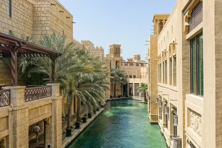 Discover serene waterways and lush palms amid traditional architecture on a private Dubai day and night tour.