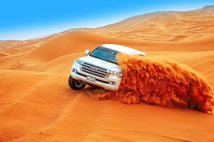 4x4 vehicle dune bashing through vibrant orange sands on a thrilling Dubai desert safari ride.