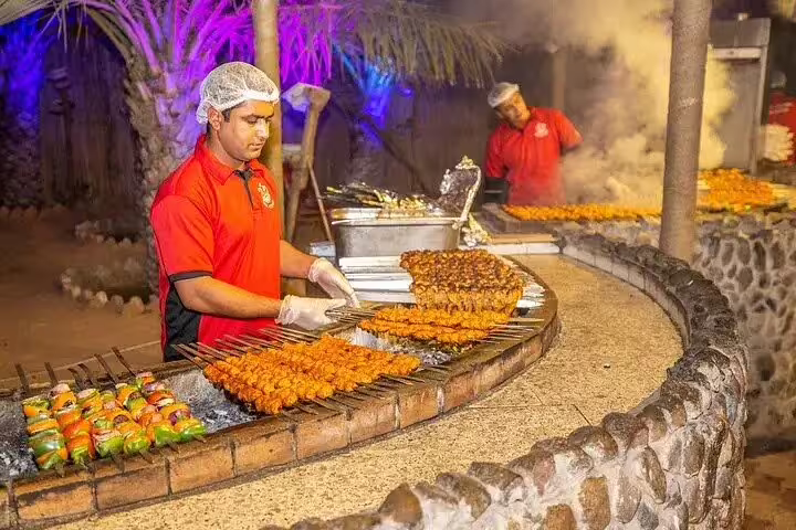 Chefs prepare delicious BBQ skewers at a Dubai desert safari, offering a premium dining experience under the stars.
