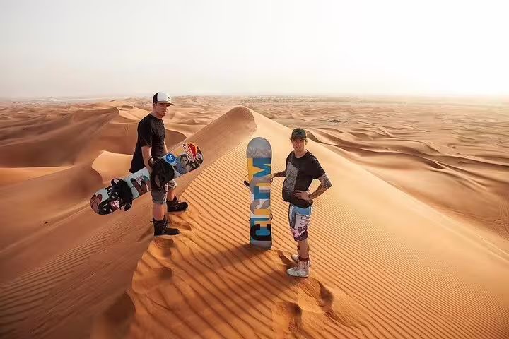 Tourists with sandboards enjoying exhilarating desert views on a Dubai dune adventure.
