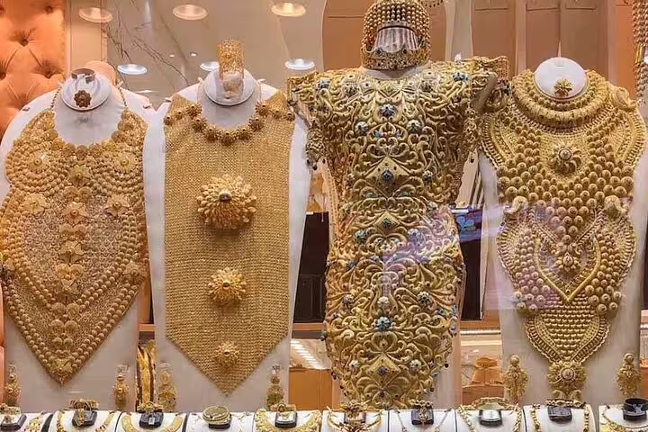 Marvel at intricate gold jewelry displays in Dubai's famous Gold Souk during your private 4x4 city tour.