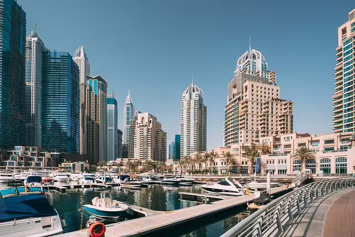 Dubai Marina skyline and yachts by the waterfront promenade, featured on a private Dubai layover tour