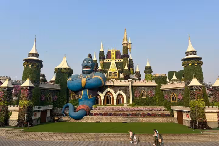 Dubai Miracle Garden floral castle with giant genie display, part of Global Village private tour with pickup