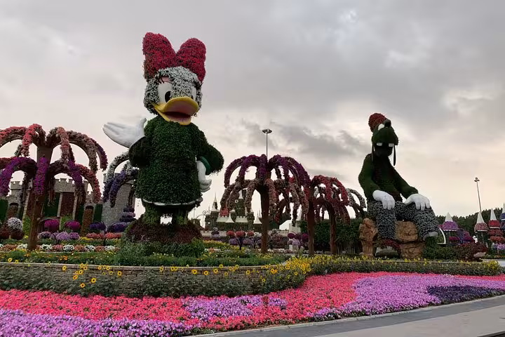 Dubai Miracle Garden floral topiary characters with vibrant flower beds, a must-see UAE attraction pass