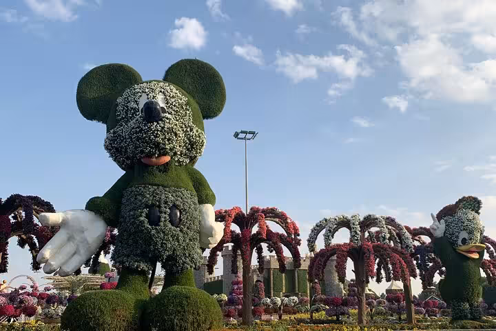 Dubai Miracle Garden Mickey Mouse floral topiary with colorful arches on Global Village tour from Fujairah