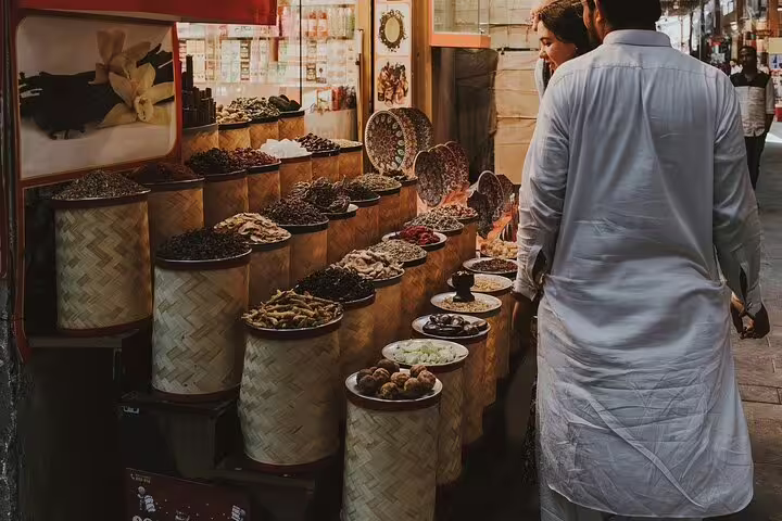 Explore Dubai Old Souk on a private customizable sightseeing tour with spice stalls and traditional market lanes