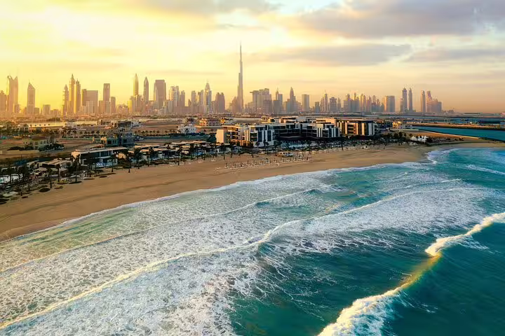 Stunning view of Dubai skyline at sunset with iconic Burj Khalifa, perfect for a magical day tour in a private vehicle.
