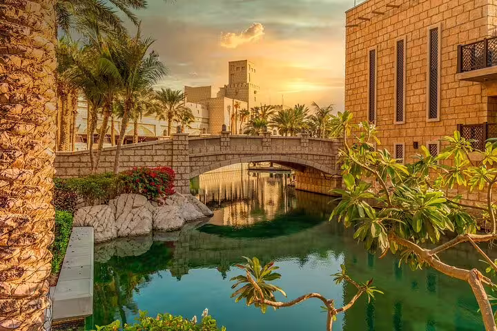 Experience a stunning sunset over Dubai's canals and historic buildings on a magical private day and night tour.