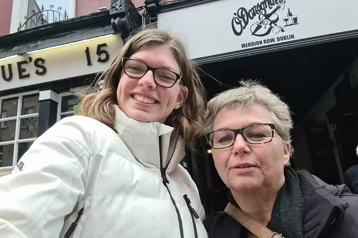 Two women smiling outside O'Donoghues pub on Merrion Row Dublin during a self-guided tour