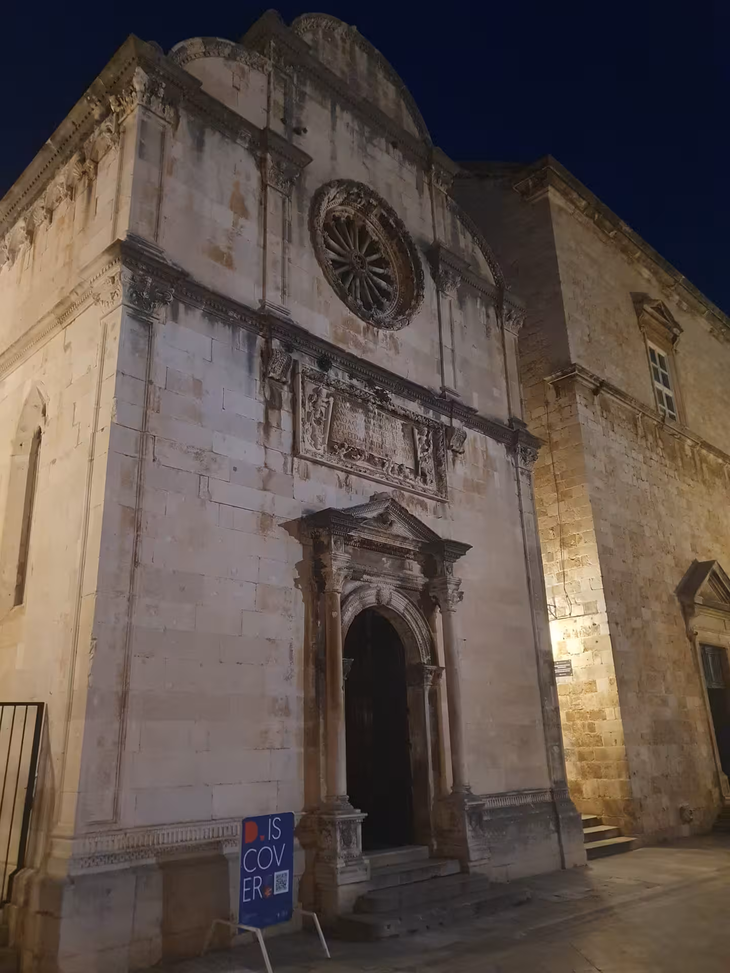 Lit Dubrovnik cathedral facade at night in Old Town, a highlight of the Dubrovnik history by night walk