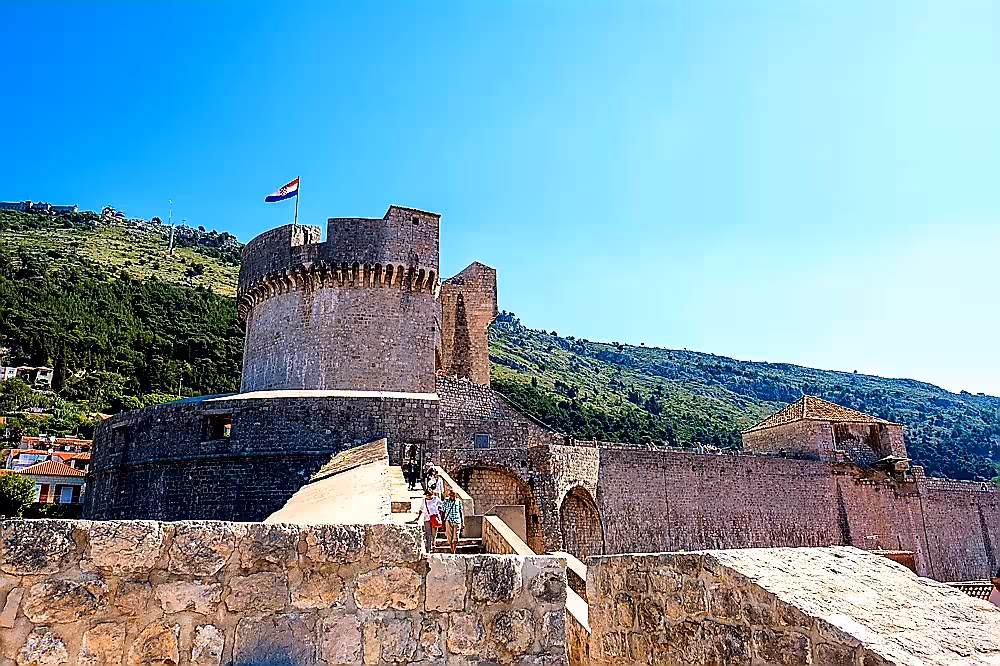 Dubrovnik city walls and fortress with Croatian flag, panoramic viewpoint on guided history and scenery tour