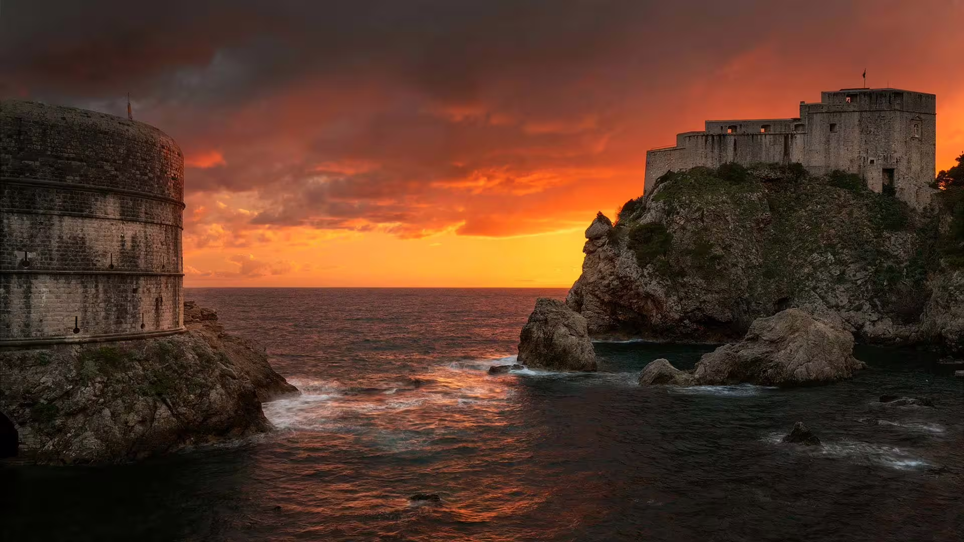 Dubrovnik city walls and Lovrijenac Fortress at sunset over the Adriatic, panoramic drive photo stop view
