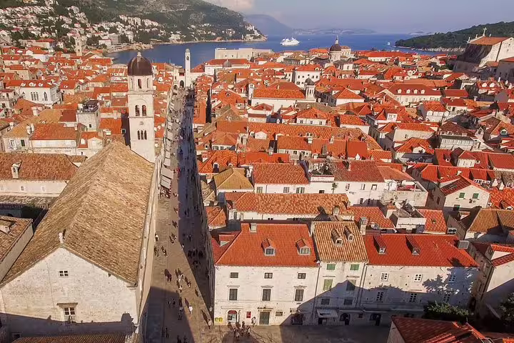 Stradun street and terracotta rooftops inside Dubrovnik city walls, scenic viewpoint on walking group tour