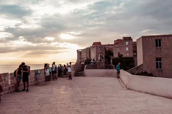 Sunset stroll on Dubrovnik city walls overlooking the Adriatic, highlight of Ancient City Walls & Wars tour