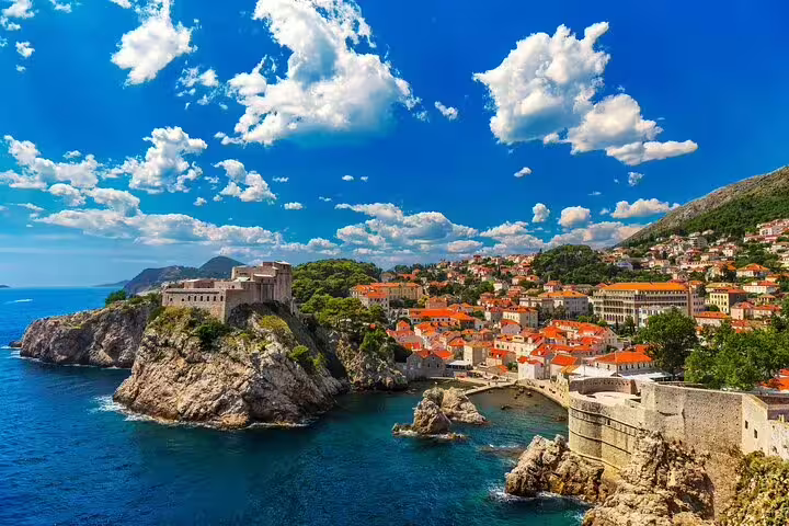 Scenic view of Dubrovnik's ancient city walls and coastline, starting point for a private full-day tour to Mostar and Medjugorje.
