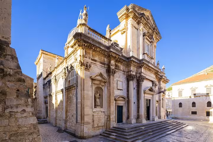 Baroque facade of Dubrovnik Cathedral with ornate stone carvings on cobblestone square in Old Town