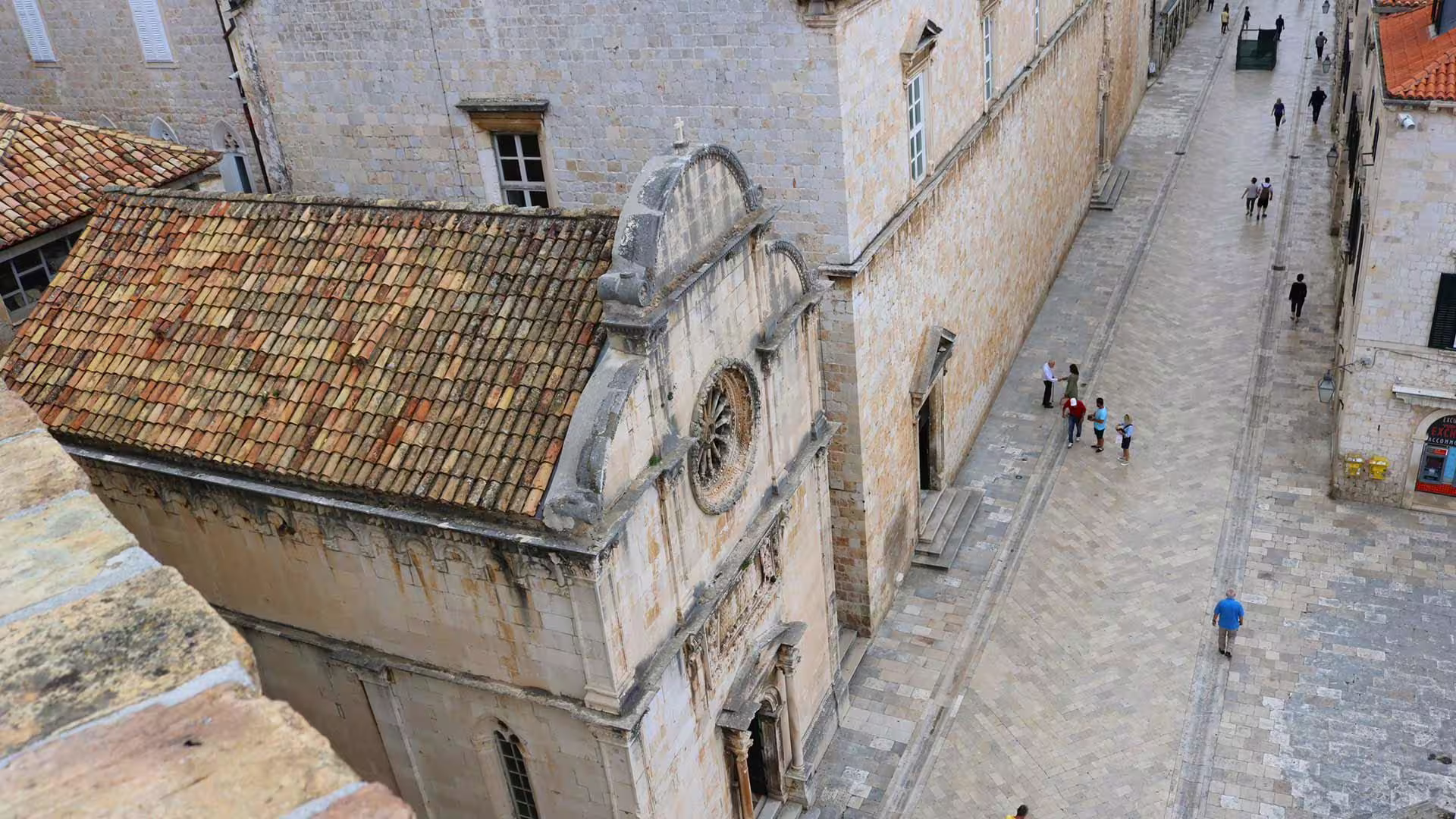 Dubrovnik Old Town guided group walking tour view from city walls over stone church and quiet lane