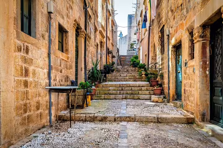 Stone alley and steps in Dubrovnik Old Town, city highlights walking tour with Croatian wine tasting