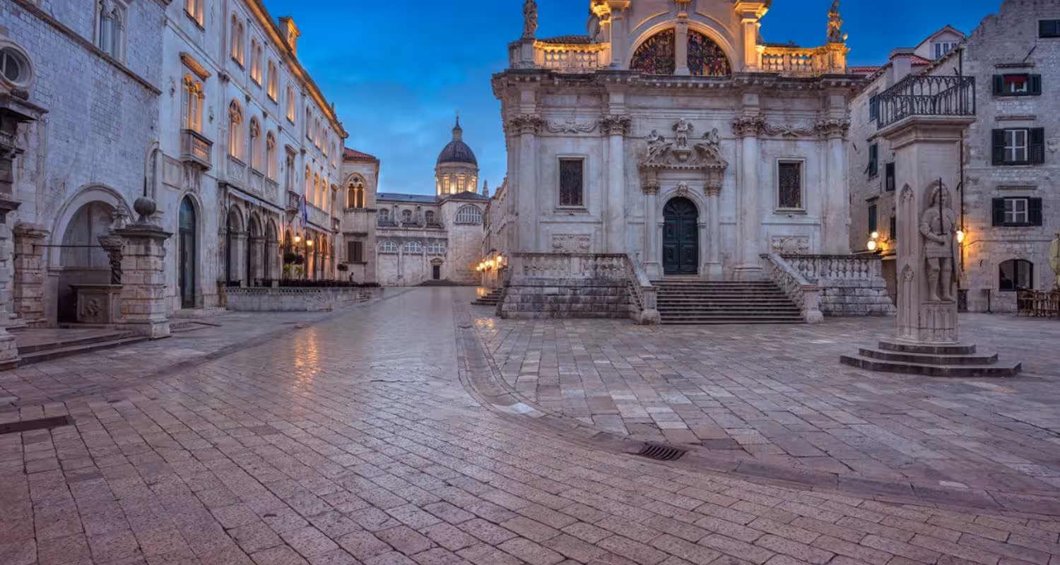 Dubrovnik's historic old town square at twilight, showcasing stunning medieval architecture in Croatia's Adriatic gem.