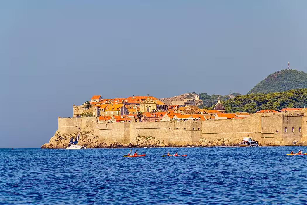 Panoramic view of Dubrovnik Old Town walls from the sea with kayaks on the Adriatic, private tour highlight