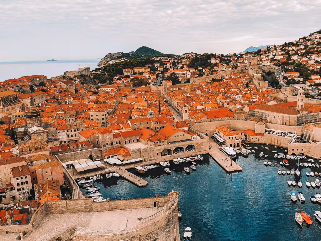 Panoramic view of Dubrovnik Old Town walls and red roofs over the Adriatic on a history and scenery city tour