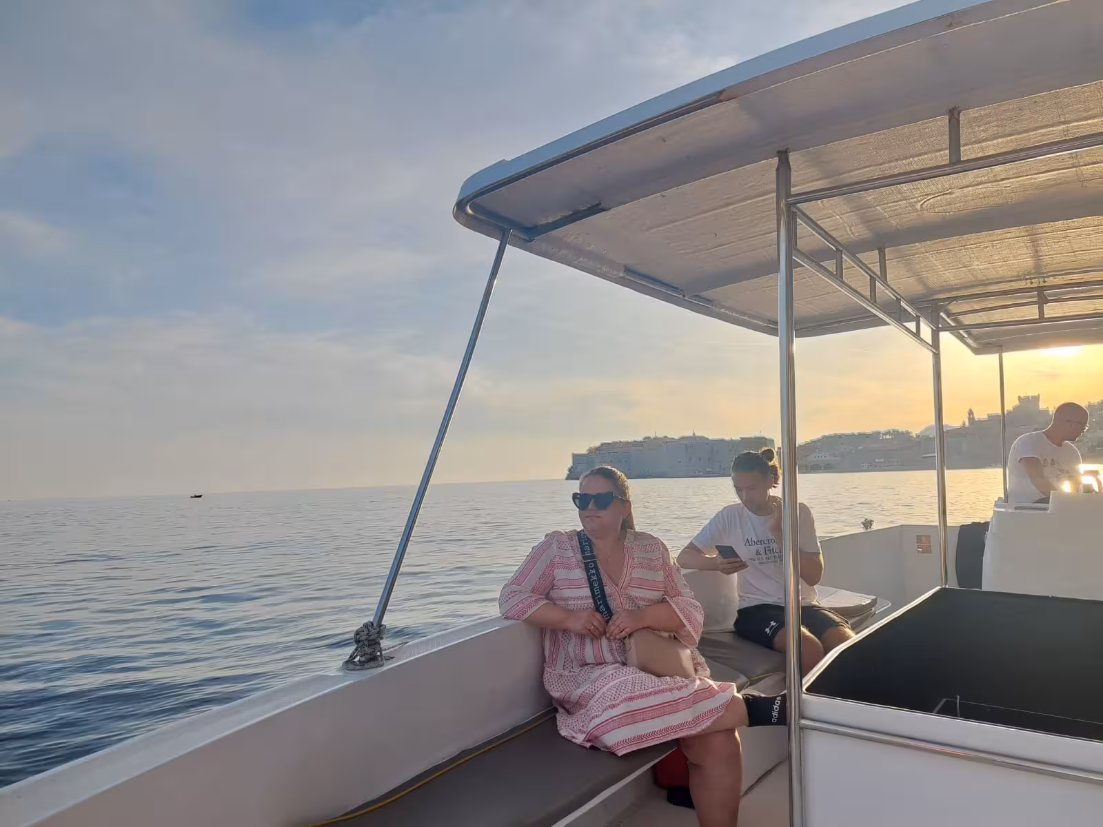 Guests relax on a sunset boat cruise in Dubrovnik, Adriatic views before Old Town night tour
