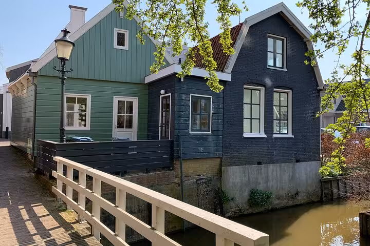 Traditional wooden house by a canal in a Dutch village, Private Tour from Amsterdam Explore the North