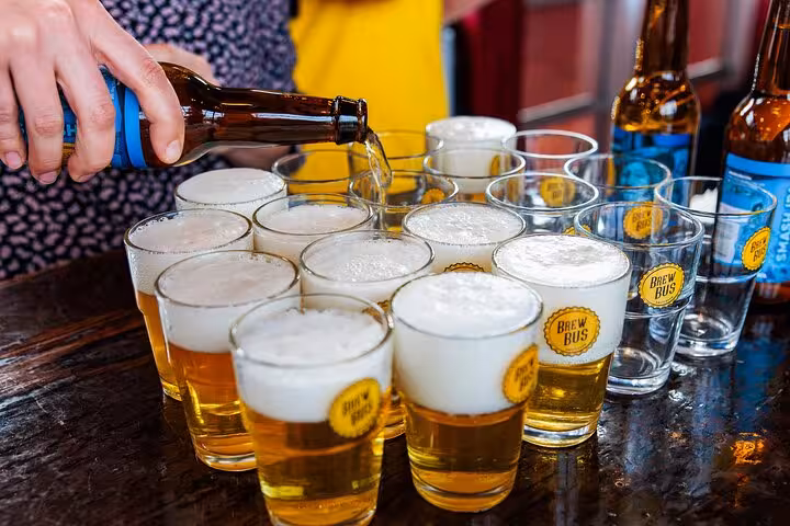 Close-up of Dutch craft beer being poured into tasting glasses on guided Amsterdam beer tour with snacks