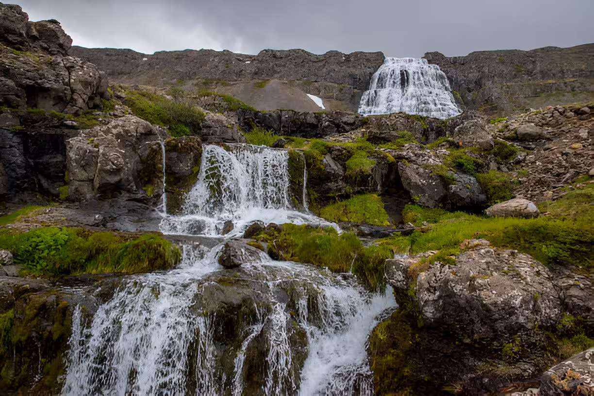 Dynjandi waterfall cascading over rocky cliffs with green moss in Iceland's Westfjords