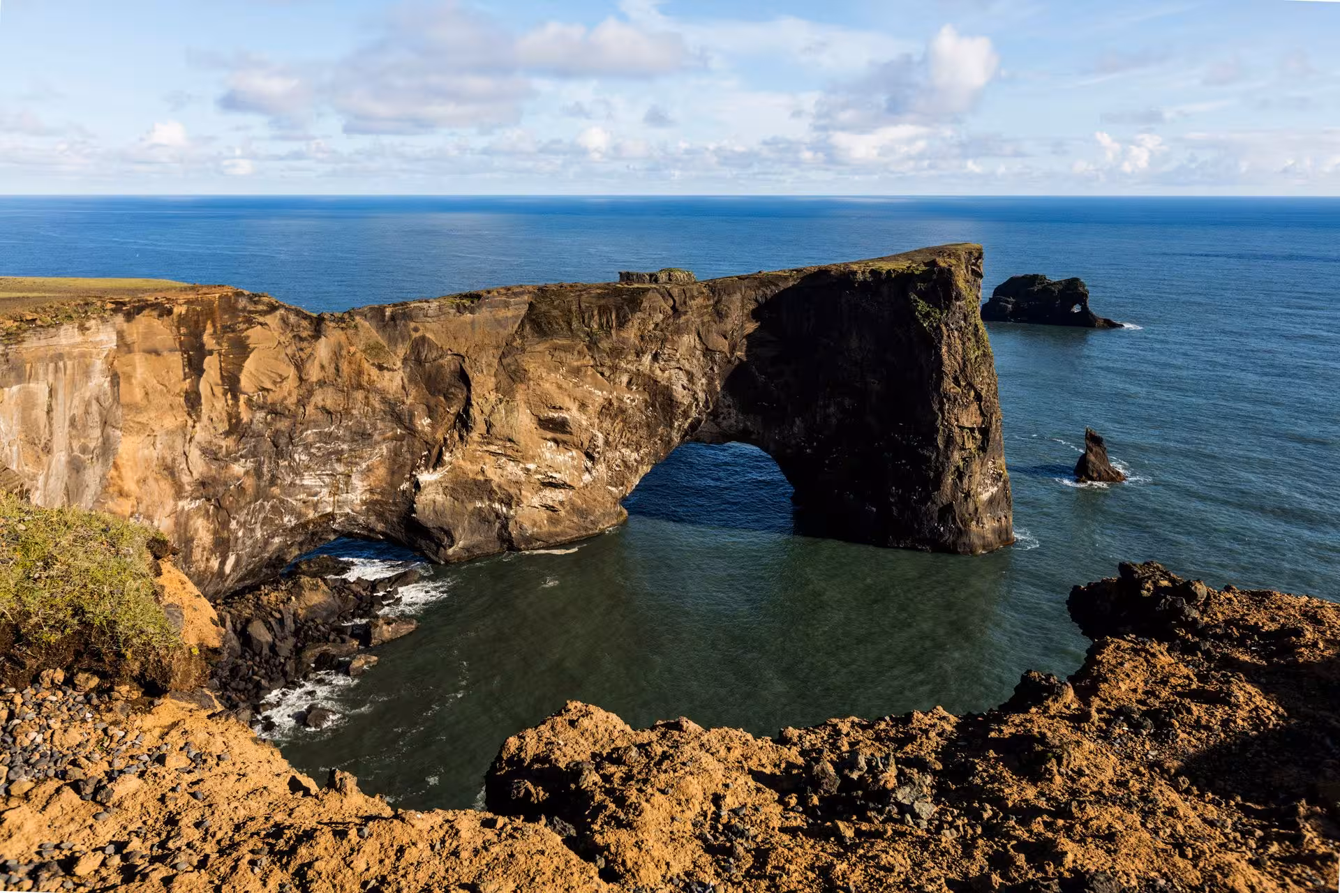 Natural rock arch over ocean at Dyrhólaey promontory on Iceland's south coast