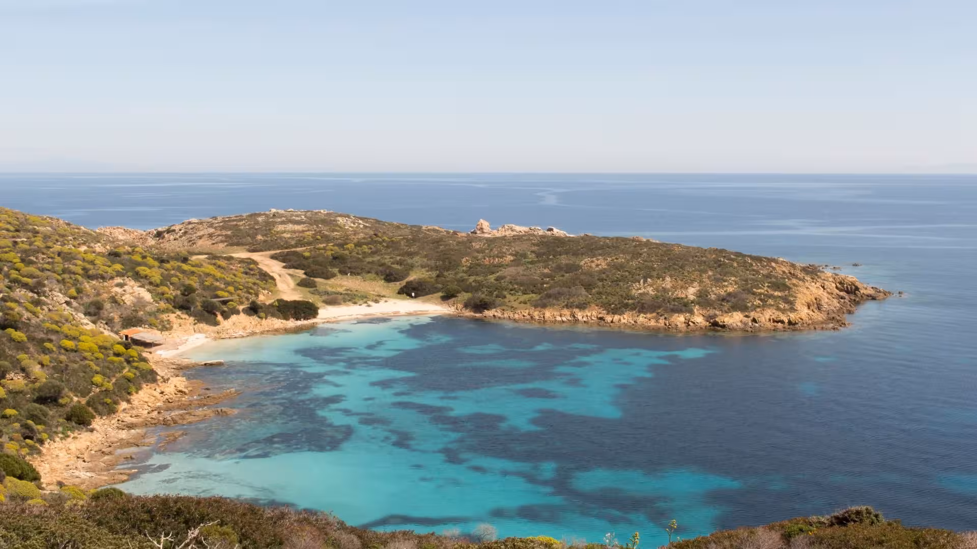 Scenic Asinara coastline with turquoise waters and lush greenery, ideal for an e-bike adventure from Porto Torres.