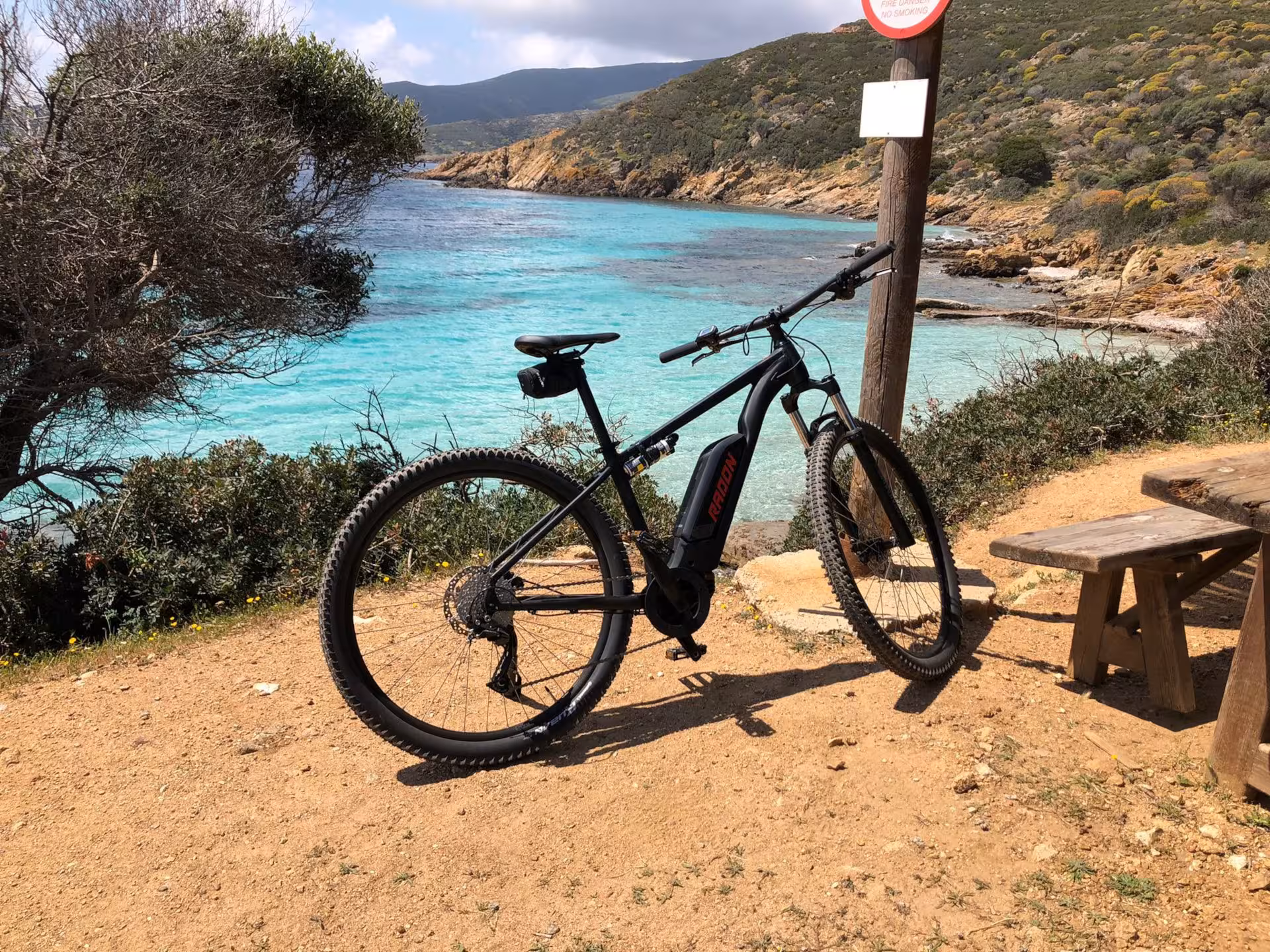 E-bike parked by the turquoise waters and scenic coastline of Asinara near Porto Torres, perfect for exploration.