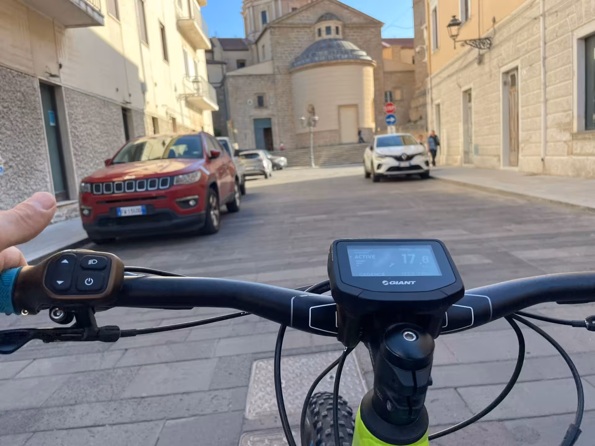 Ride an e-bike through the charming streets of Oristano, Sardinia, and explore the historic architecture.