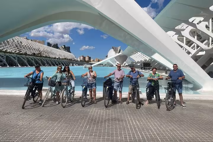 E-bike group at Valencia City of Arts and Sciences by turquoise pool on all-in-one beaches and old town tour