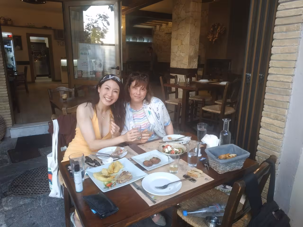 Guests enjoying local meze at a cozy taverna, part of the Eco Bike food tour tasting experience