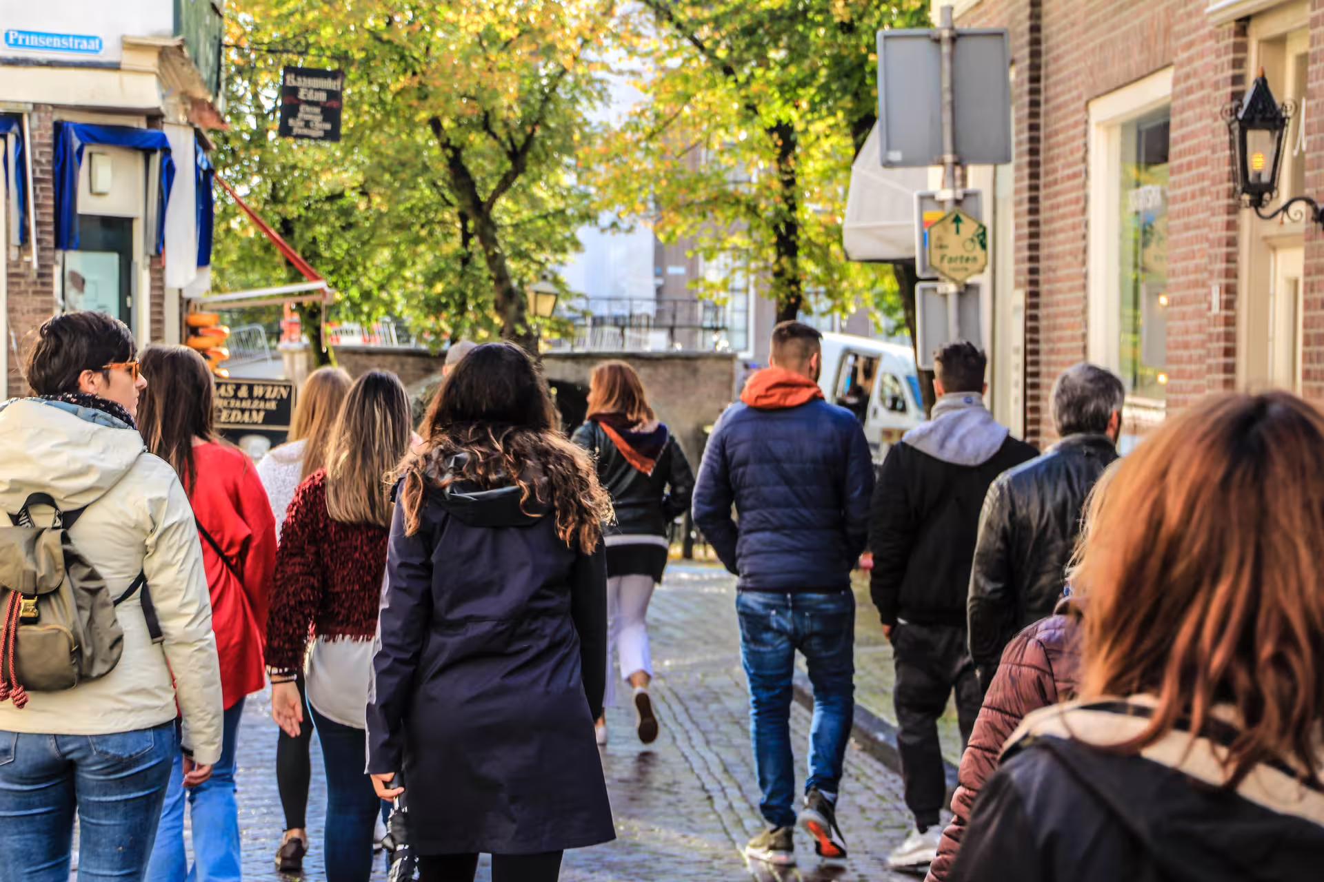 Tourists explore the charming streets of Edam during a guided tour of Zaanse Schans, Edam, Volendam, and Marken, Netherlands.